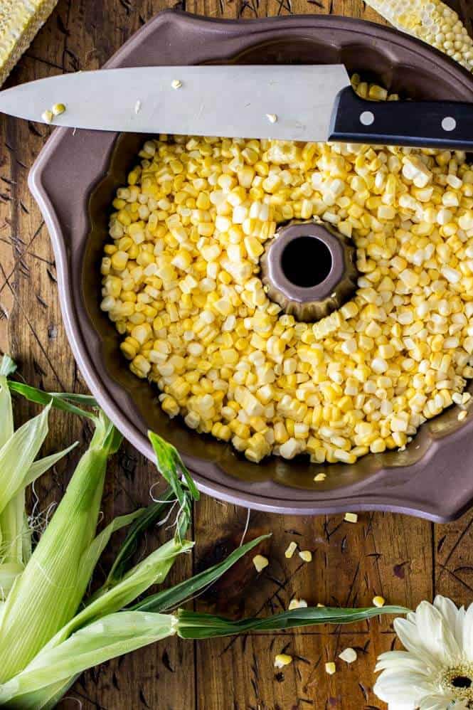 Using a bundt pan to easily cut the corn off of the cob 