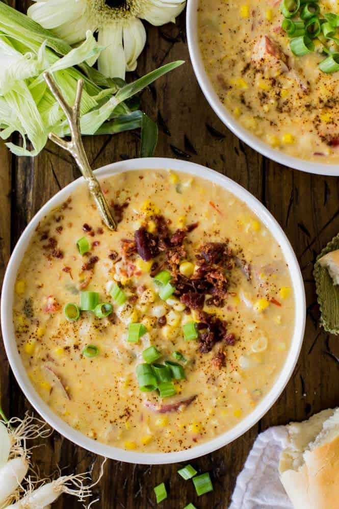 Overhead view of summer corn chowder in white bowl