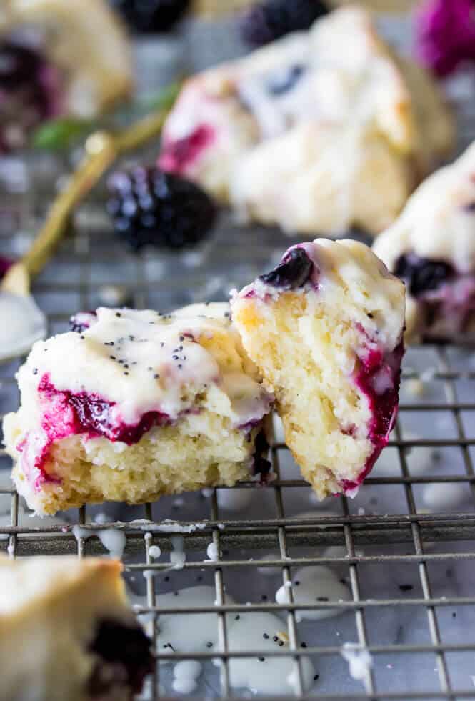 Triple berry scone glazed with icing on cooling rack