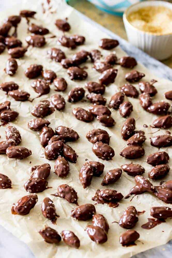 Chocolate coated almonds on parchment paper