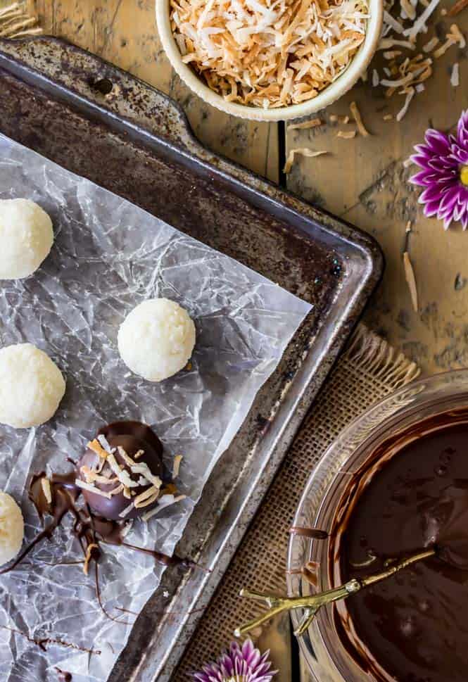 Dipping coconut truffles in dark chocolate