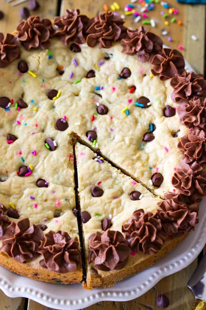 A giant soft baked chocolate chip cookie cake! Complete with sprinkles and chocolate frosting! || Sugar Spun Run