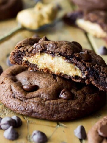Stack of Peanut Butter Stuffed chocolate chip cookies, broken to see peanut butter filling
