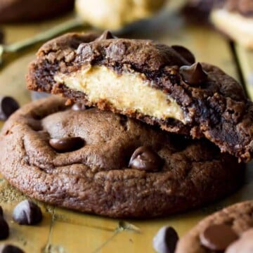 Stack of Peanut Butter Stuffed chocolate chip cookies, broken to see peanut butter filling