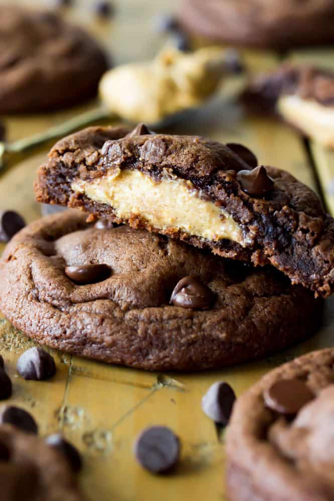 Stack of Peanut Butter Stuffed chocolate chip cookies, broken to see peanut butter filling