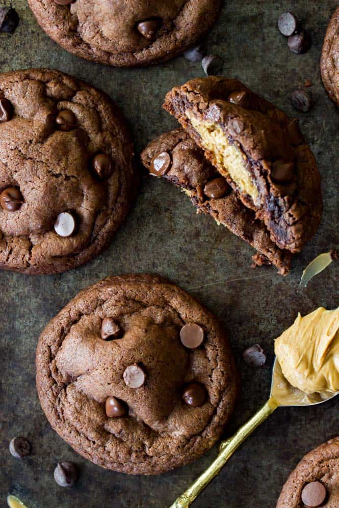 Stack of Peanut Butter Stuffed chocolate chip cookies, broken to see peanut butter filling