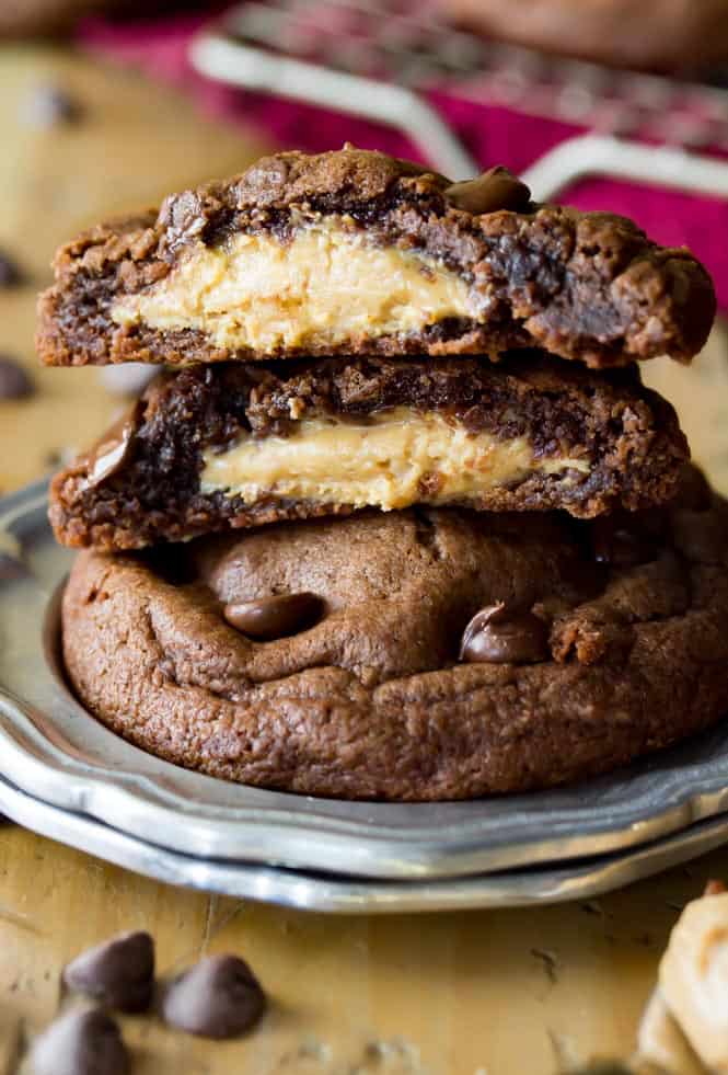 Stack of Peanut Butter Stuffed chocolate chip cookies, broken to see peanut butter filling