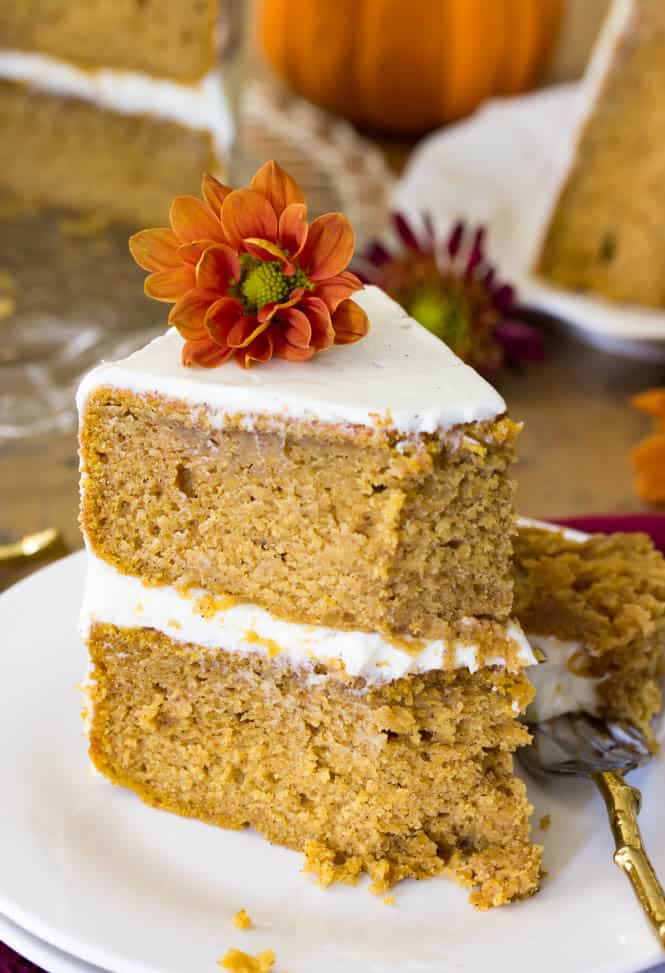 Slice of frosted pumpkin layer cake on plate