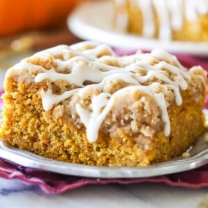 Square of pumpkin coffee cake on silver plate. Drizzled with vanilla glaze.