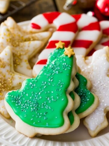 Sugar cookies shaped and decorated as stars, candy canes, snowflakes and christmas trees