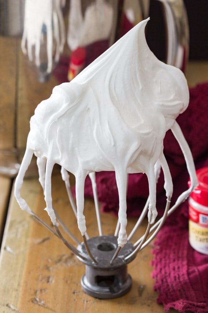 How to make meringue: whip the ingredients to stiff peaks, which are shown here on the whisk attachment