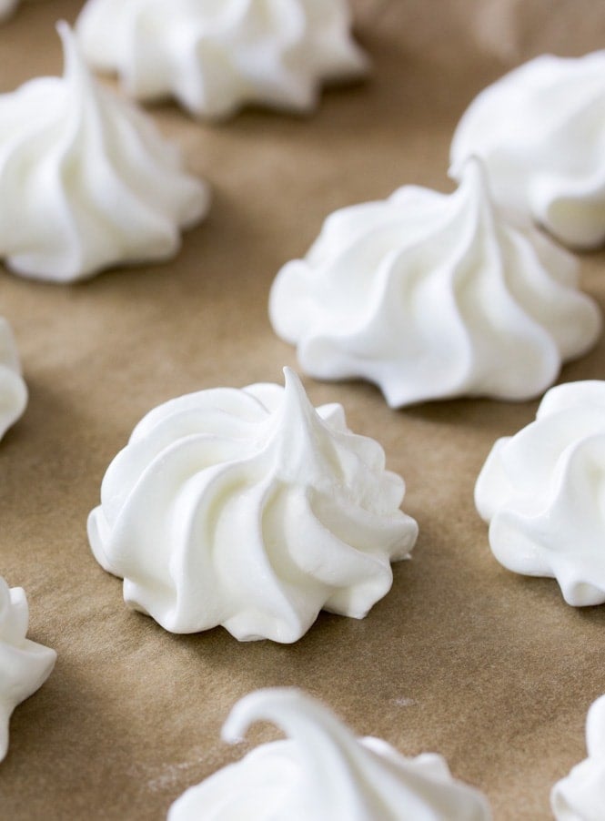 Meringue cookies that have been piped onto a baking sheet