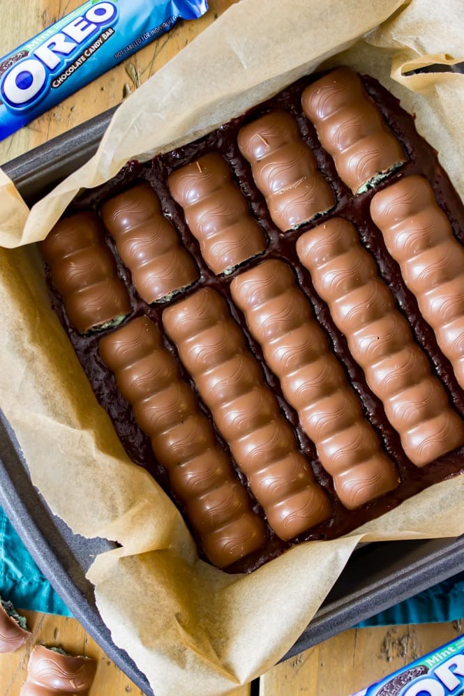 Overhead of oreo mint candy bars placed into brownie batter pan