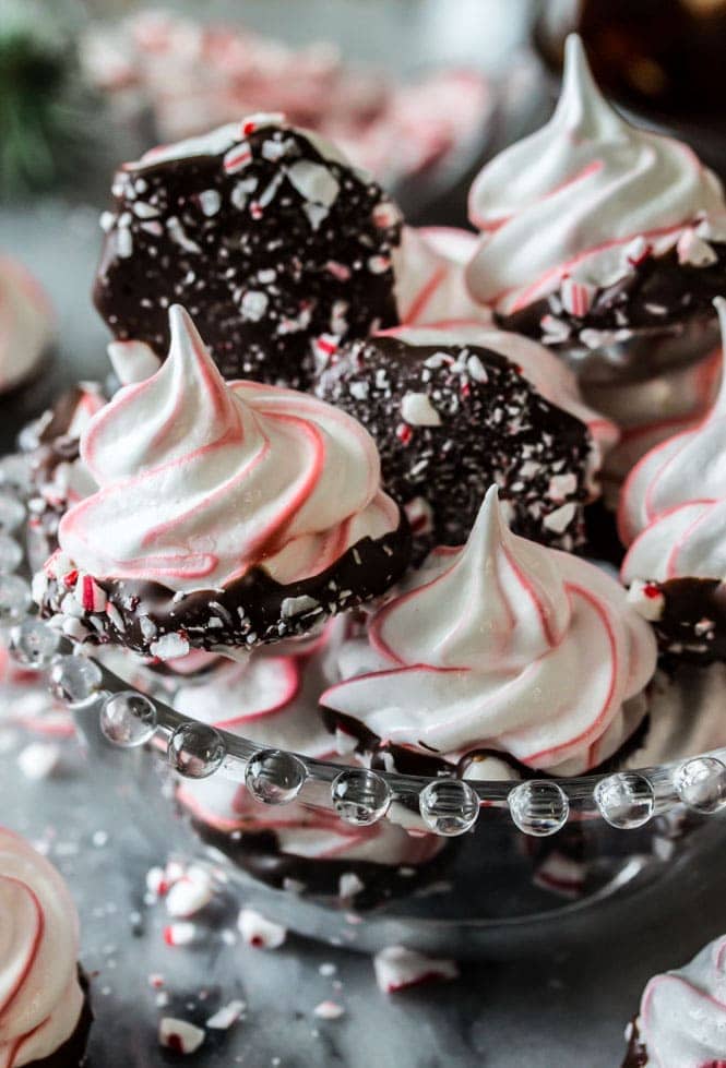 Meringues that have been colored red and white and dipped in chocolate