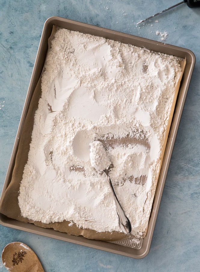 How to heat treat flour: flour spread on baking sheet