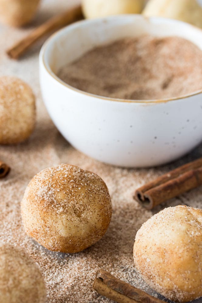 Making Snickerdoodles: rolling snickerdoodle cookie dough through cinnamon and sugar