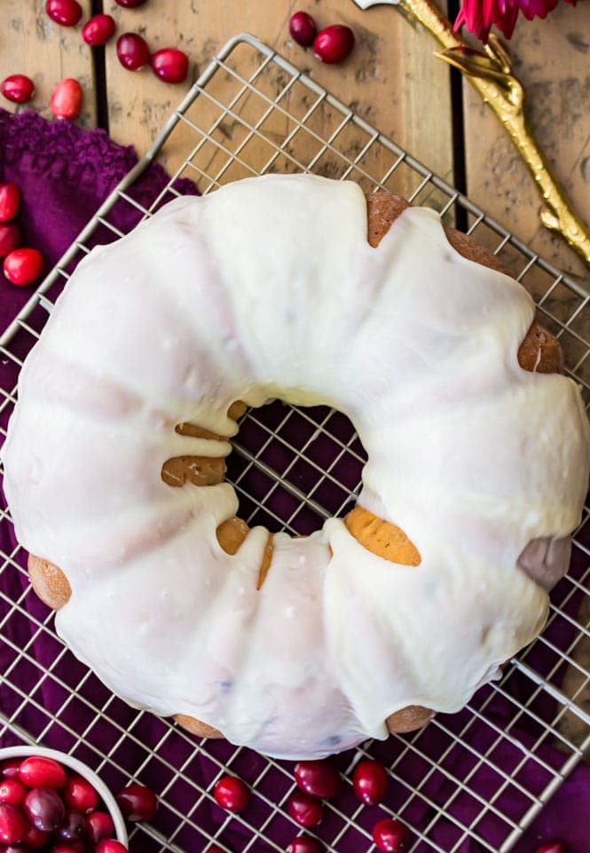 An overhead view of cranberry bundt cake covered in white chocolate glaze