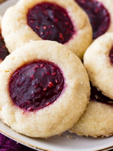 Thumbrint cookies with raspberry filling on plate