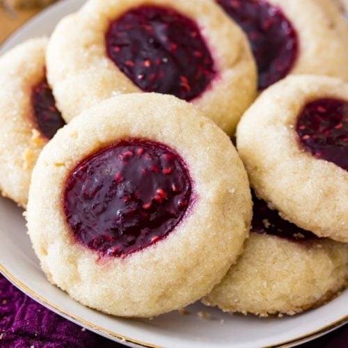 Thumbrint cookies with raspberry filling on plate