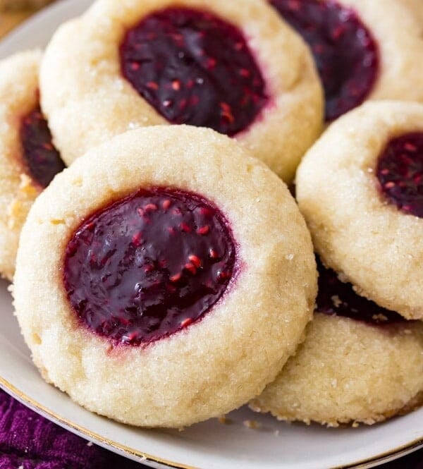 Thumbrint cookies with raspberry filling on plate