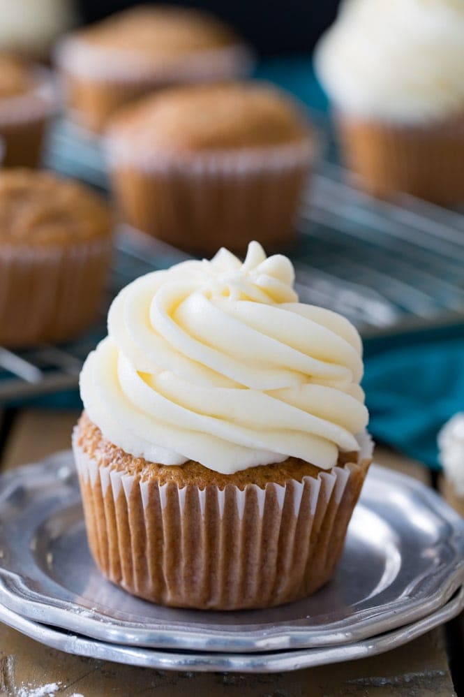 Cream cheese frosting piped on top of a cupcake