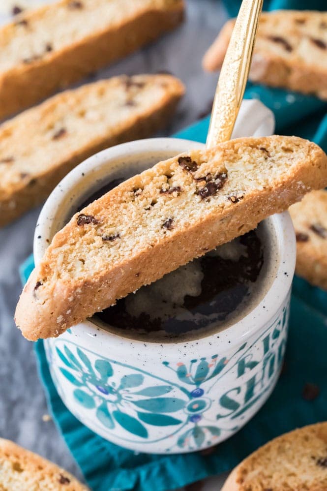 Biscotti resting on a hot cup of coffee