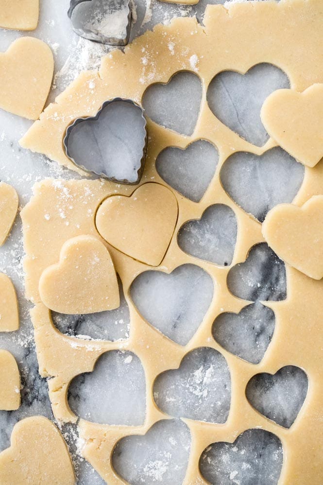 Cookie dough rolled out, cut into heart shapes