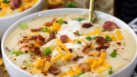 Potato soup in bowl, with toppings