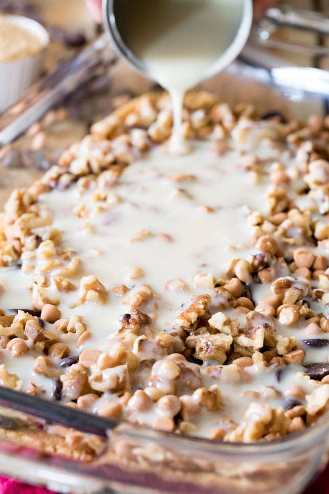 Layering your ingredients for 7 Layer Bars