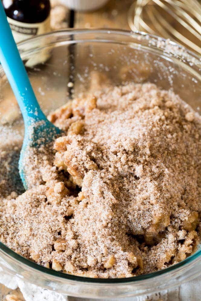 Walnuts in a bowl with brown sugar and vanilla extract