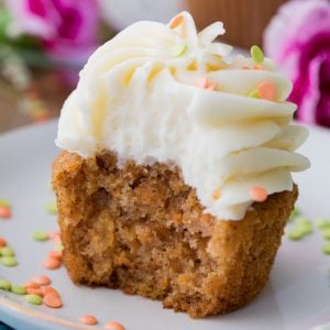 Carrot cake cupcake with white frosting on a plate