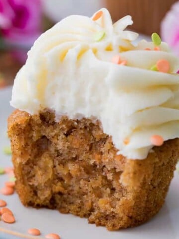Carrot cake cupcake with white frosting on a plate
