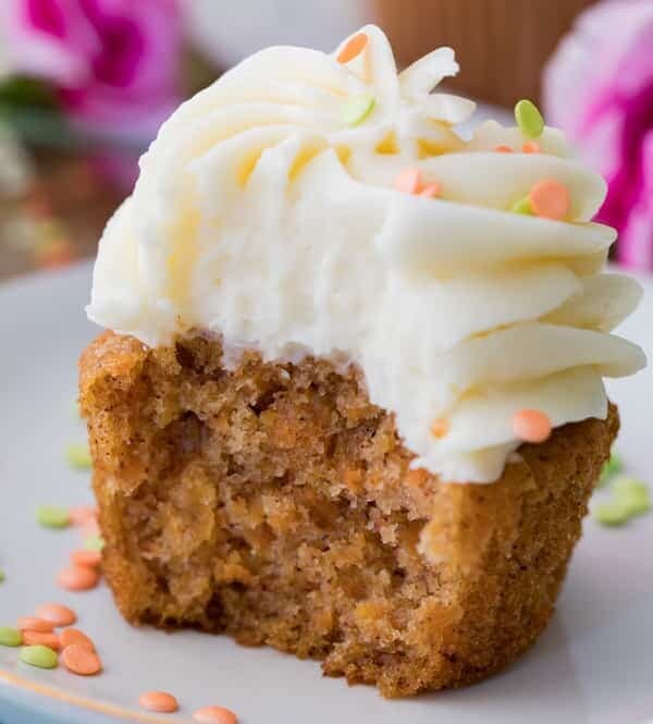 Carrot cake cupcake with white frosting on a plate