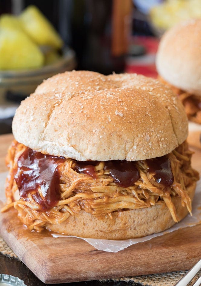 A BBQ Chicken sandwich with extra bbq sauce over the meat