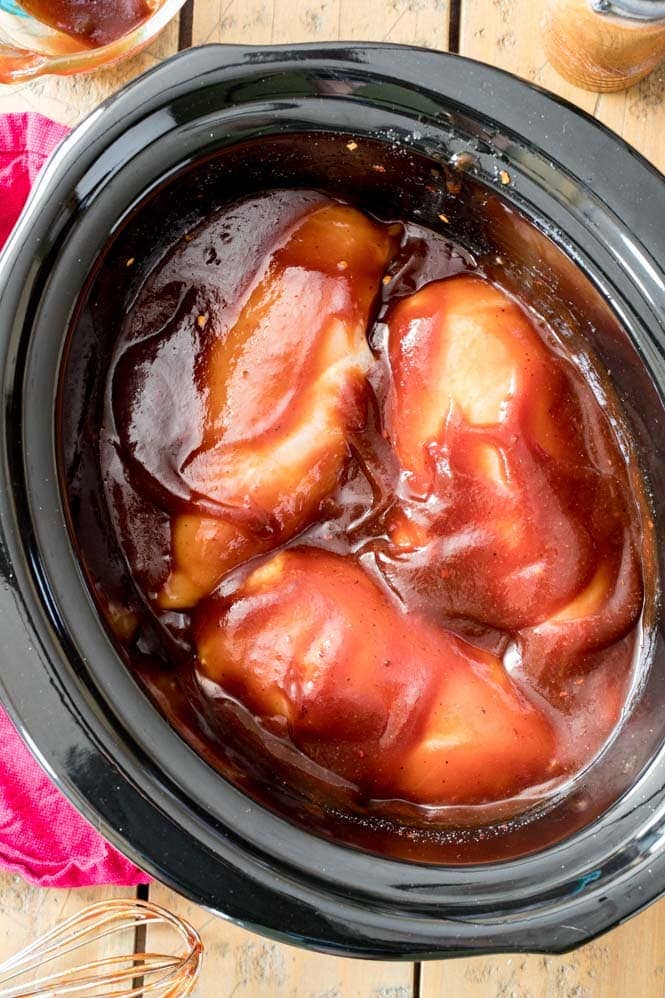 Chicken breast in a barbecue marinade in the slow cooker