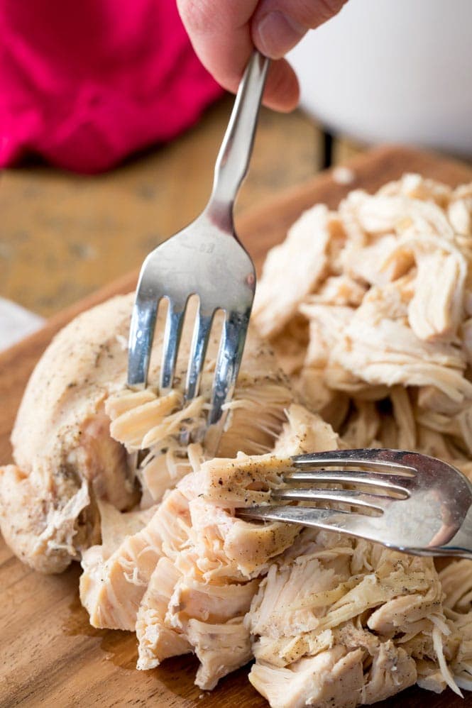 Shredding a chicken breast with two forks