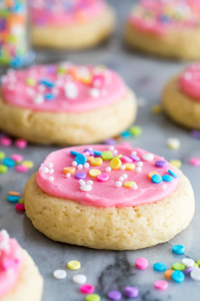 Soft Frosted Sugar Cookies that require no chilling, no rolling pins, and no cookie cutters!  These are similar to the famous "Lofthouse Cookies" and are topped off with a sweet vanilla buttercream frosting and sprinkles.