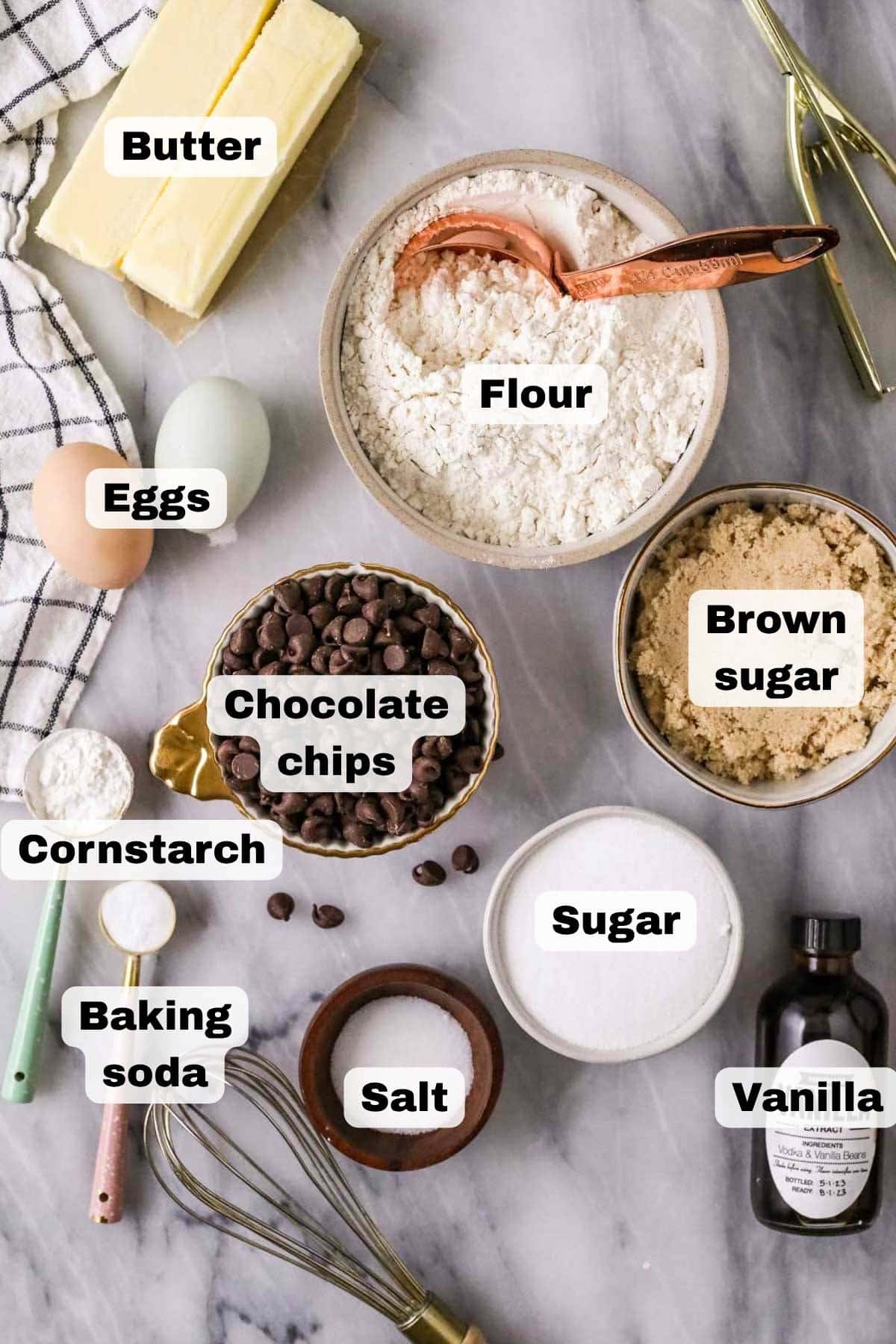 Overhead view of the ingredients needed for the best chocolate chip cookies, all ingredients labeled.