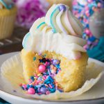 Piñata cupcake: topped with vanilla frosting, sprinkles pouring out of center