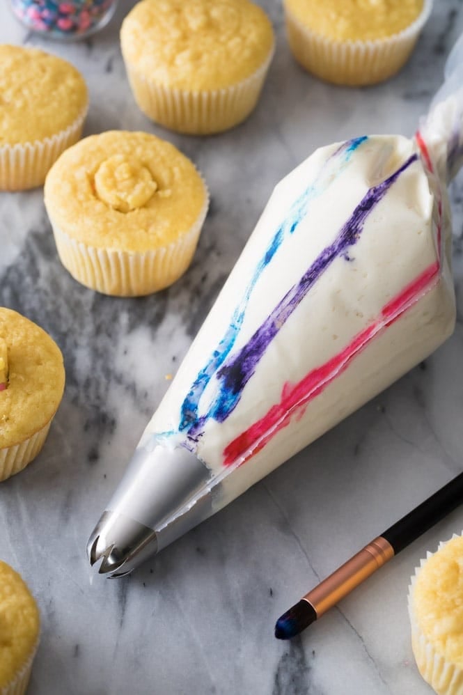 A piping bag that's been painted with food coloring stripes to make a swirled frosting