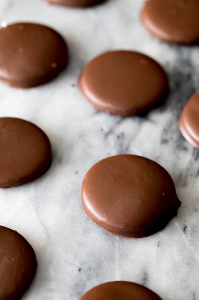 Chocolate mint cookies arranged on an angle across a marble slab