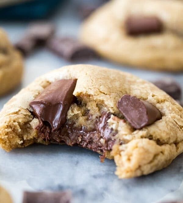 Chocolate chip cookie with bite missing showing melted gooey chocolate