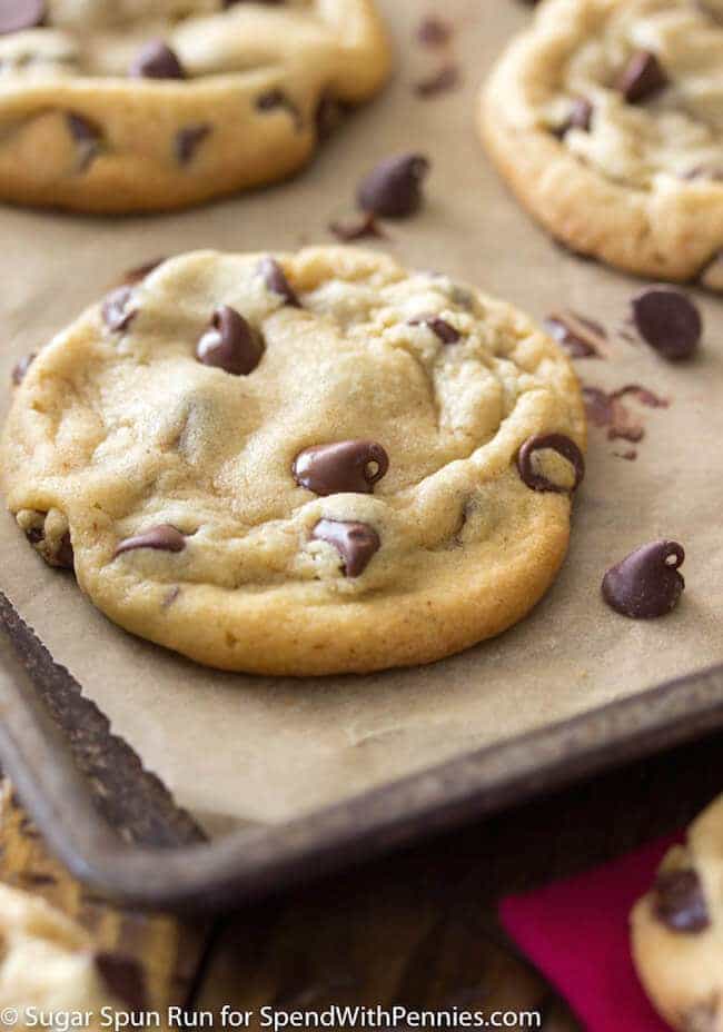 A chocolate chip cookie on a baking sheet