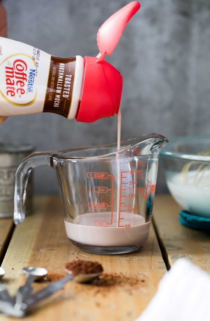 Toasted marshmallow mocha coffee mate creamer pouring into glass measuring cup