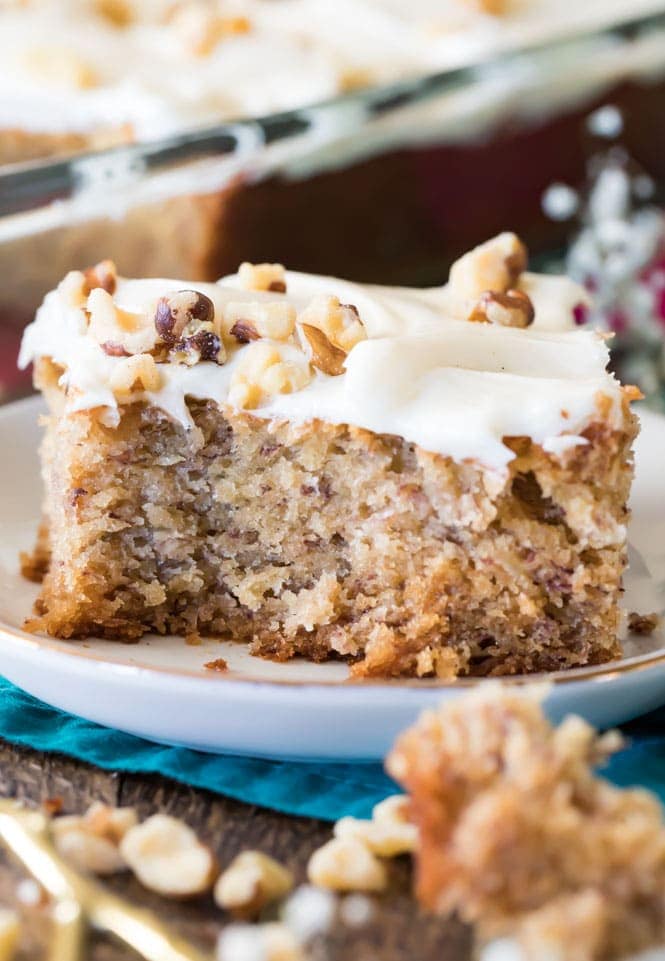 slice of banana cake with cream cheese frosting and nuts