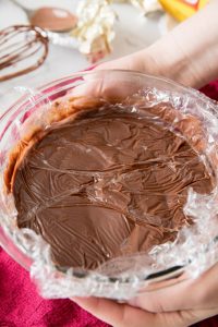 Plastic wrap pressed onto chocolate pudding in bowl