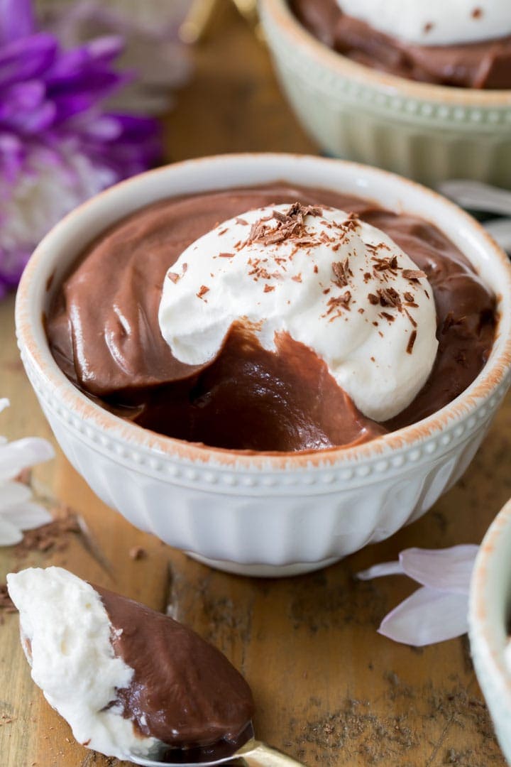 Chocolate pudding topped with whipped cream in bowl