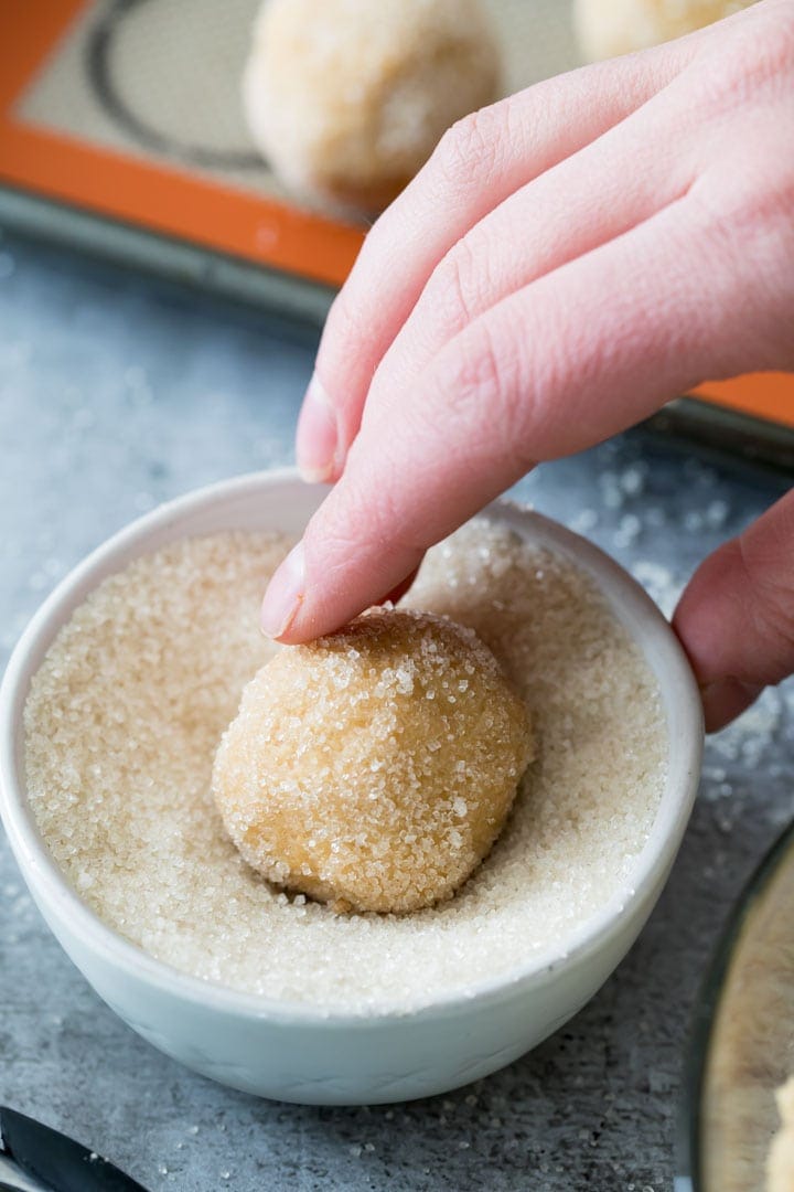 Rolling peanut butter cookie dough in sugar