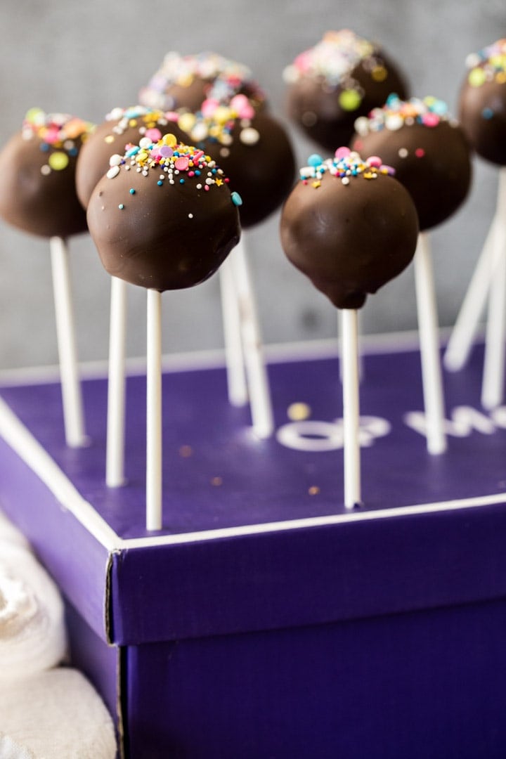 Cookie dough pops standing on shoe box
