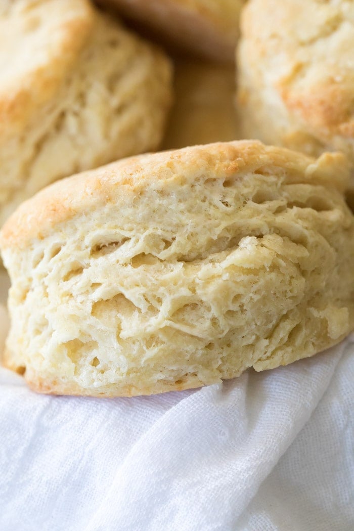 A buttery soft homemade biscuit in a basket